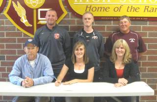 Ross High's Taylor Ahrens is joined by family and coaches after signing a letter of intent with Rio Grande