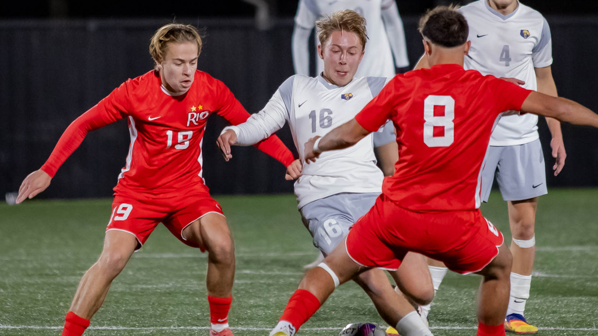 Rio Grande's Will Perry (19) and Nahuel Coppiz (8) try to get the ball away from WVU-Tech's Hugo Roman during Wednesday night's 2-1 loss to the Golden Bears in the RSC Championship game in Beckley, W.Va.